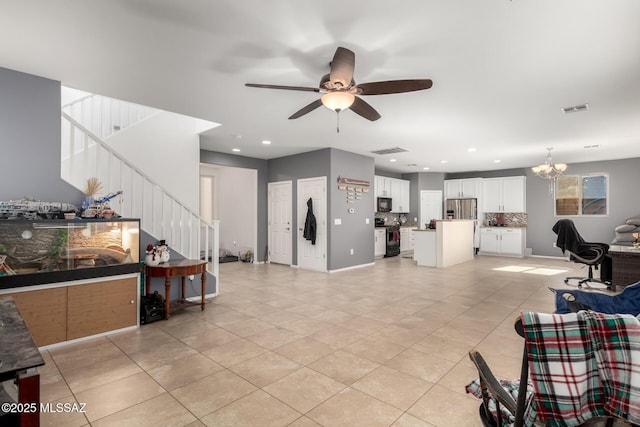 tiled living room featuring ceiling fan with notable chandelier