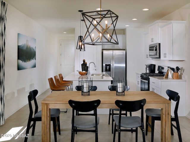 dining area with light tile patterned flooring, a chandelier, and sink