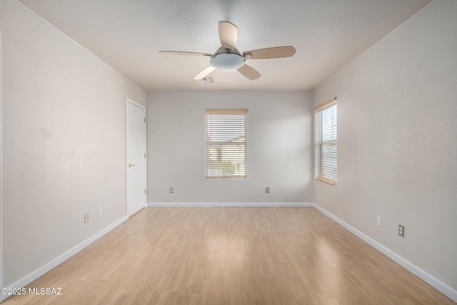 unfurnished room featuring ceiling fan and light wood-type flooring