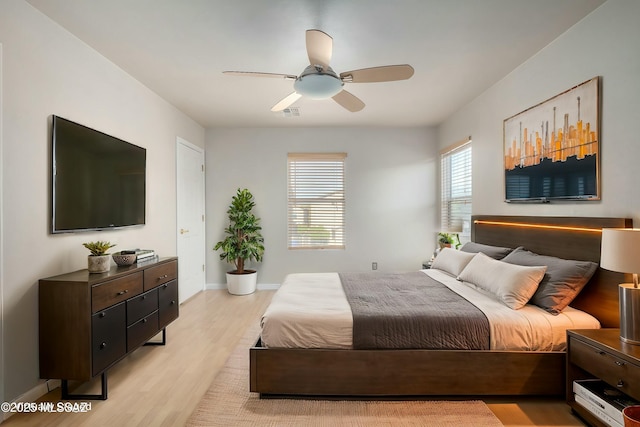 bedroom with ceiling fan and light hardwood / wood-style flooring