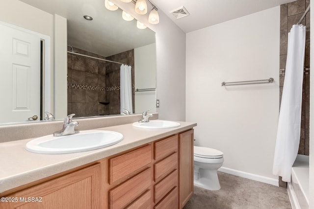 bathroom featuring vanity, walk in shower, and toilet