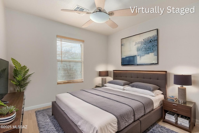 bedroom with light wood-type flooring, baseboards, visible vents, and ceiling fan