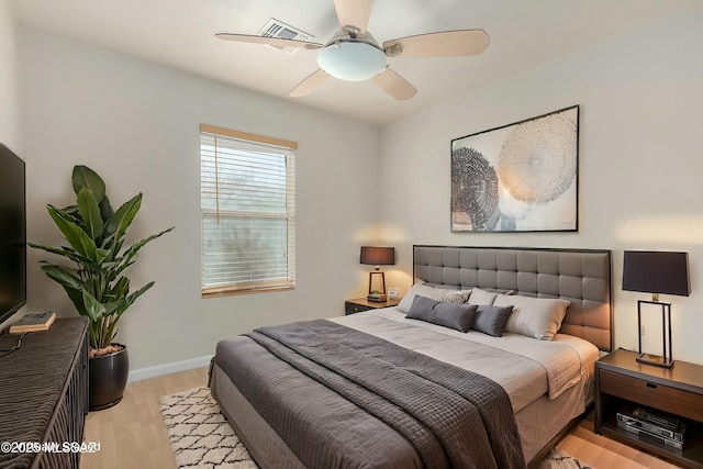 bedroom with ceiling fan and light wood-type flooring