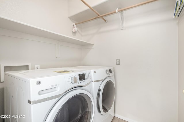 laundry room with washer and dryer, laundry area, and baseboards