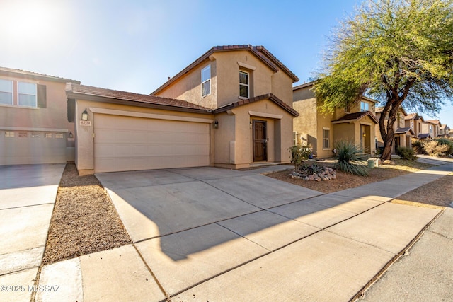 mediterranean / spanish-style home featuring stucco siding, concrete driveway, an attached garage, and a tiled roof