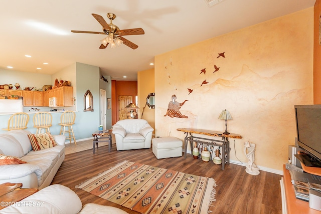 living room featuring dark hardwood / wood-style flooring and ceiling fan