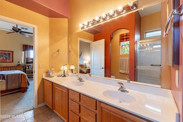 bathroom with walk in shower, tile patterned floors, toilet, vanity, and ceiling fan