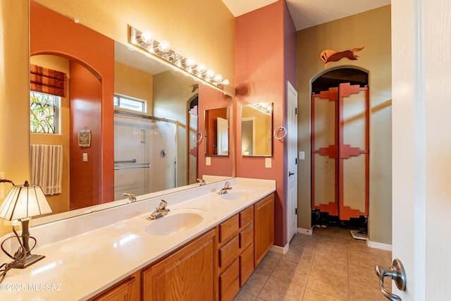 bathroom featuring vanity, an enclosed shower, and tile patterned flooring