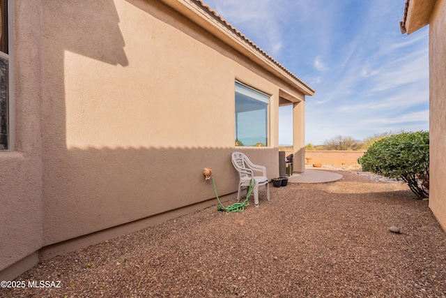 view of property exterior with a patio