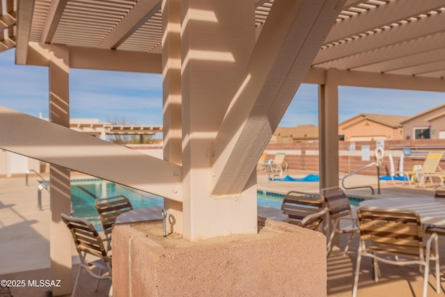 view of patio featuring a bar and a pergola