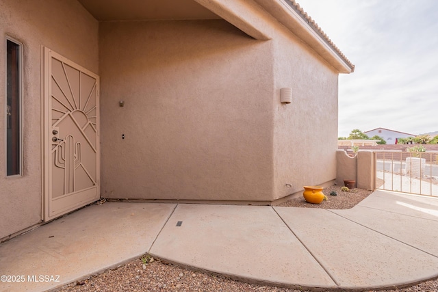 view of exterior entry featuring a patio