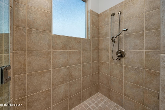 bathroom with a tile shower