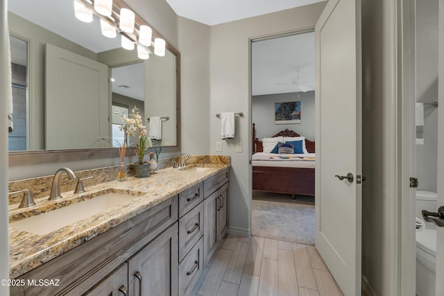 bathroom featuring vanity, ceiling fan, hardwood / wood-style flooring, and toilet