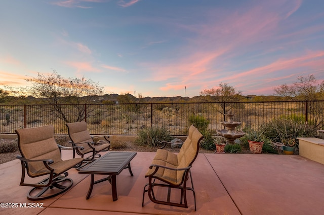 view of patio terrace at dusk