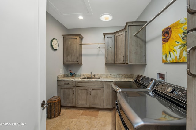 laundry room with cabinets, sink, and washing machine and clothes dryer