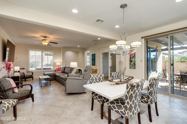 dining room featuring ceiling fan with notable chandelier and light tile patterned floors