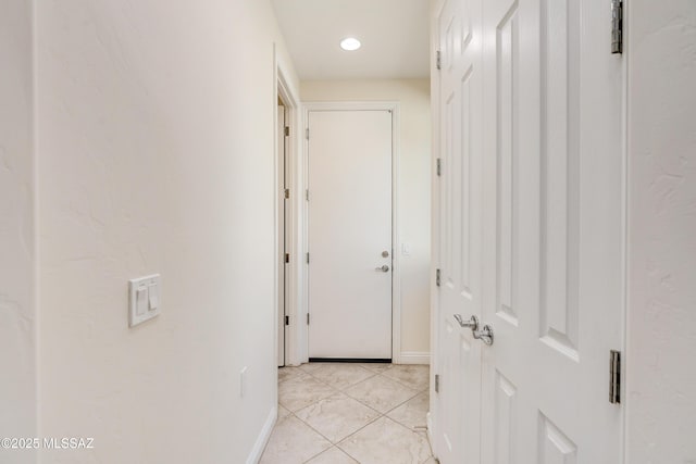 hall with light tile patterned floors