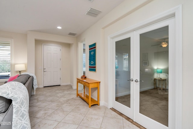 entrance foyer with light tile patterned floors and french doors