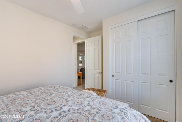 bedroom featuring ceiling fan and a closet