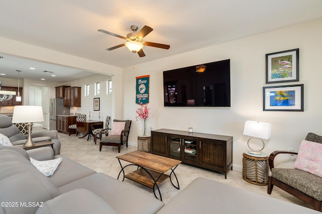 living room featuring light tile patterned flooring and ceiling fan