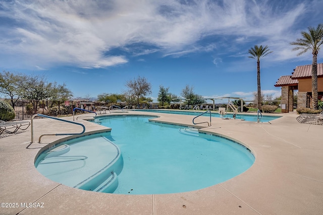 view of swimming pool featuring a patio area