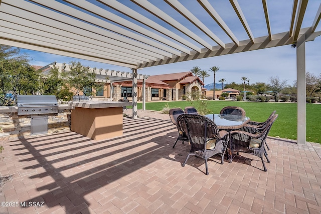 view of patio with an outdoor kitchen, grilling area, and a pergola