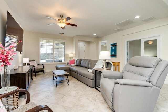 living room featuring ceiling fan and light tile patterned floors