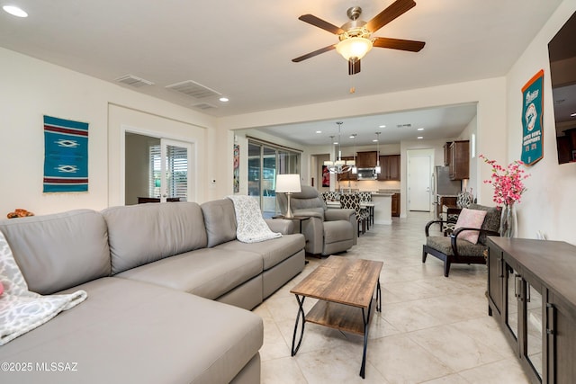 living room featuring light tile patterned floors and ceiling fan