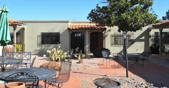 view of front of home featuring a fire pit and a patio area