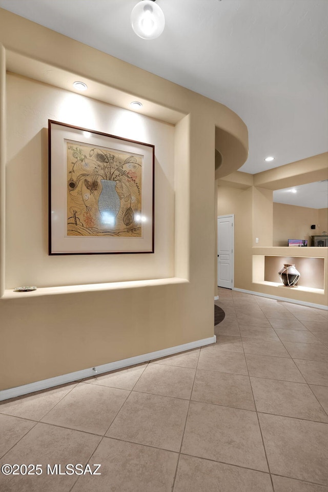 hall with tile patterned flooring and baseboards