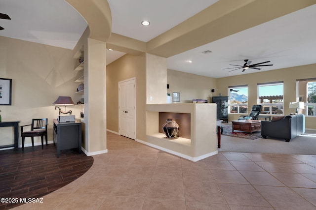 tiled living room featuring baseboards, a ceiling fan, and recessed lighting