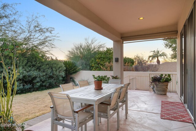 patio terrace at dusk featuring outdoor dining space
