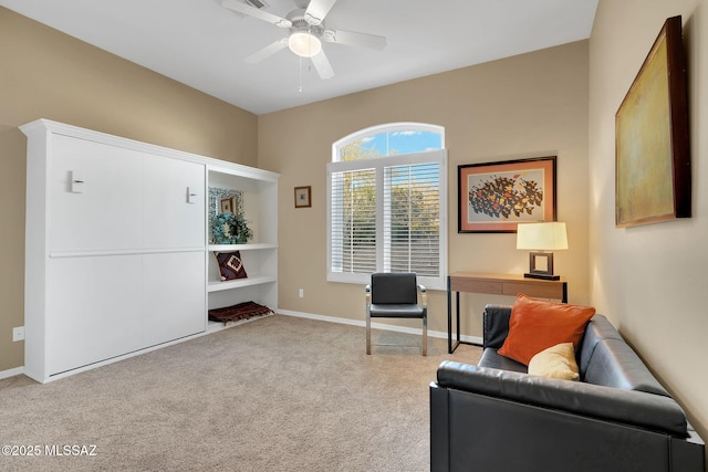 sitting room with carpet flooring, baseboards, and a ceiling fan