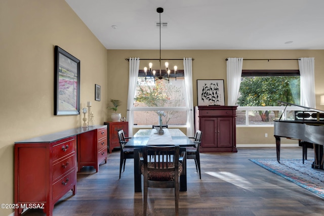 dining room with baseboards, a notable chandelier, dark wood-style flooring, and visible vents