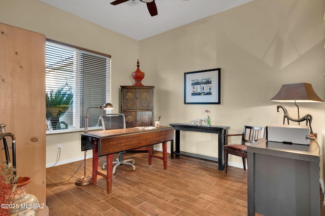 office area featuring baseboards, a ceiling fan, and wood finish floors