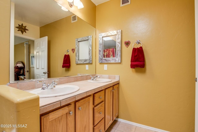 bathroom featuring tile patterned flooring and vanity