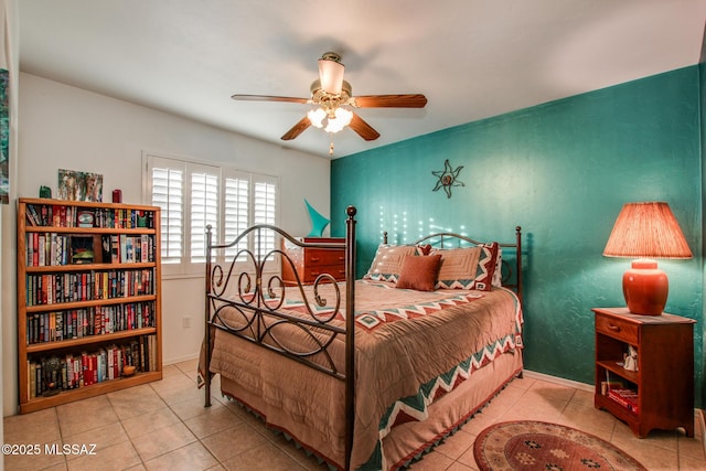 bedroom with ceiling fan and light tile patterned floors