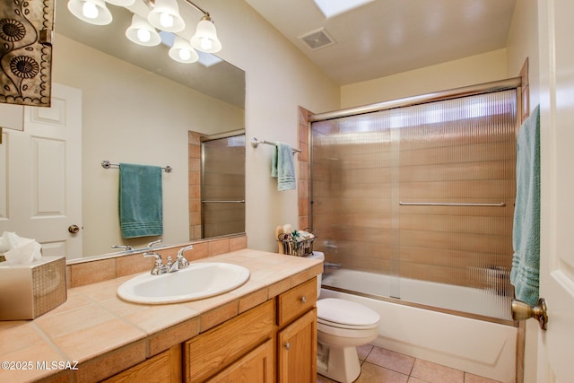 full bathroom featuring tile patterned flooring, enclosed tub / shower combo, vanity, toilet, and an inviting chandelier