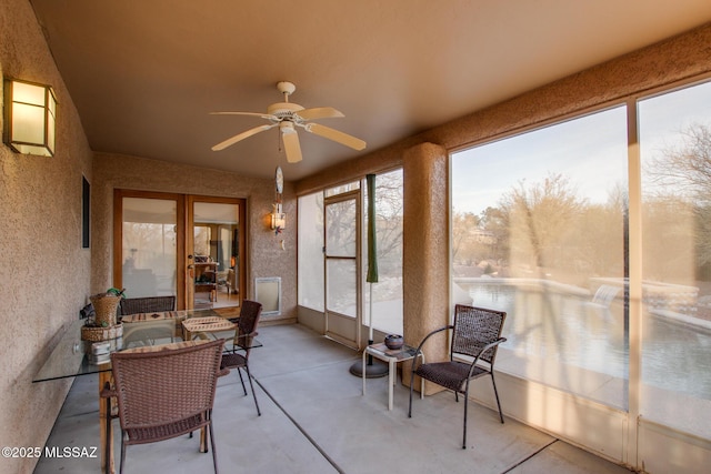 sunroom / solarium with ceiling fan and a healthy amount of sunlight