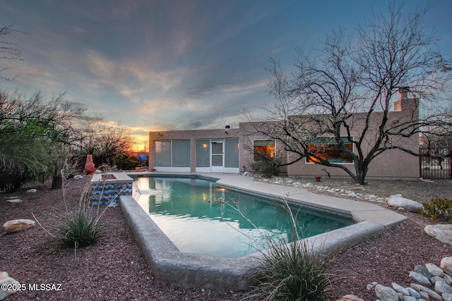 view of pool at dusk