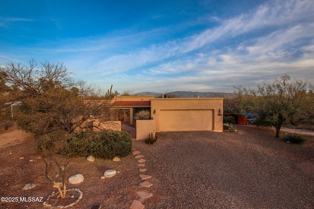 pueblo revival-style home with a garage