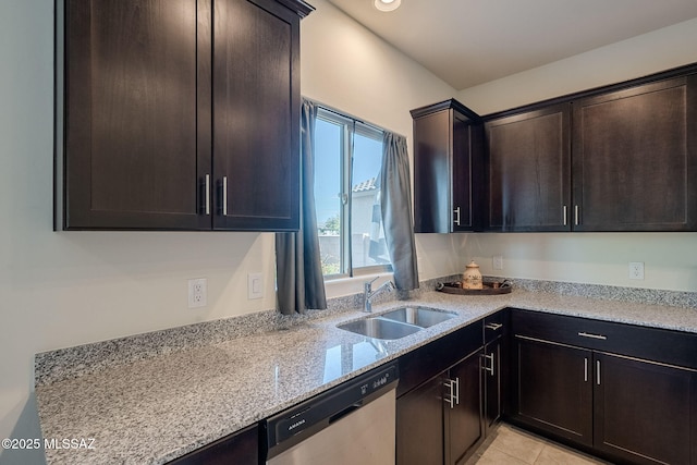 kitchen featuring light stone counters, sink, stainless steel dishwasher, and dark brown cabinets