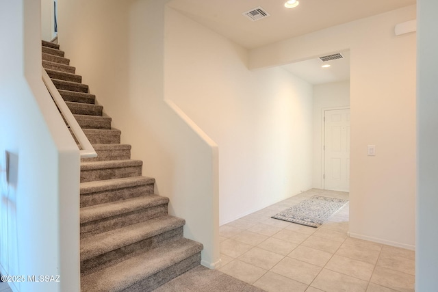 stairs featuring tile patterned floors