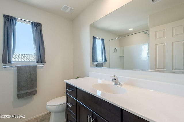 bathroom with vanity, toilet, walk in shower, and tile patterned floors