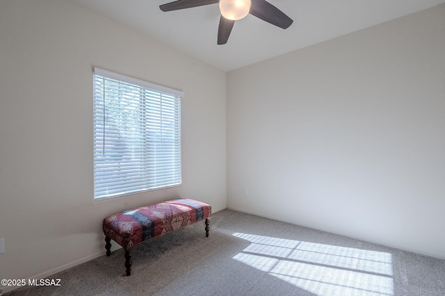 living area featuring ceiling fan and carpet