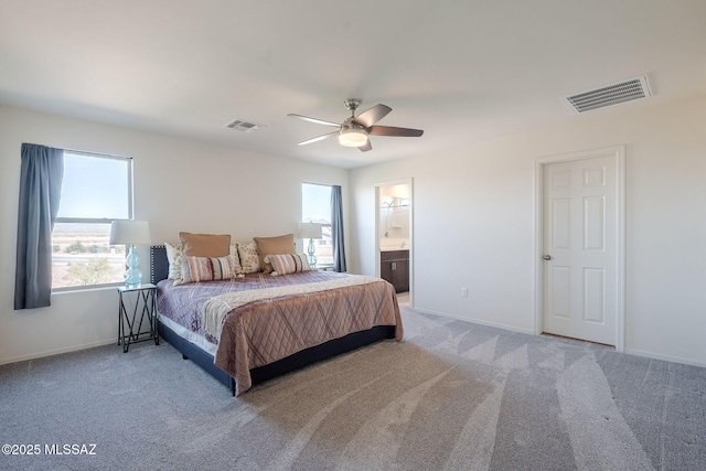 bedroom featuring carpet flooring, ceiling fan, and ensuite bathroom