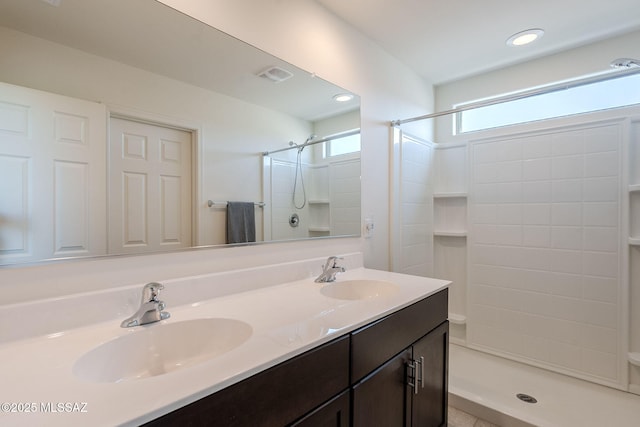 bathroom with a shower and vanity