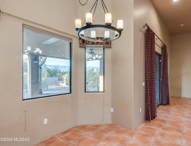 interior space with a notable chandelier and light tile patterned flooring