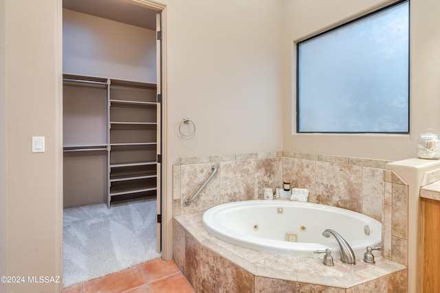 bathroom with tile patterned floors and tiled bath