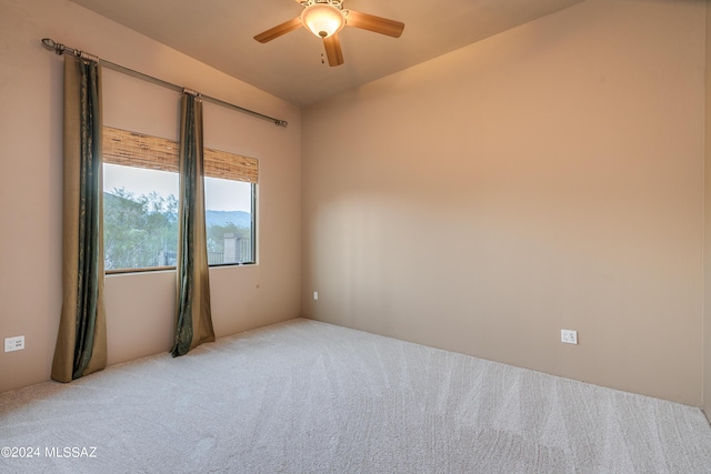 unfurnished room with ceiling fan and carpet